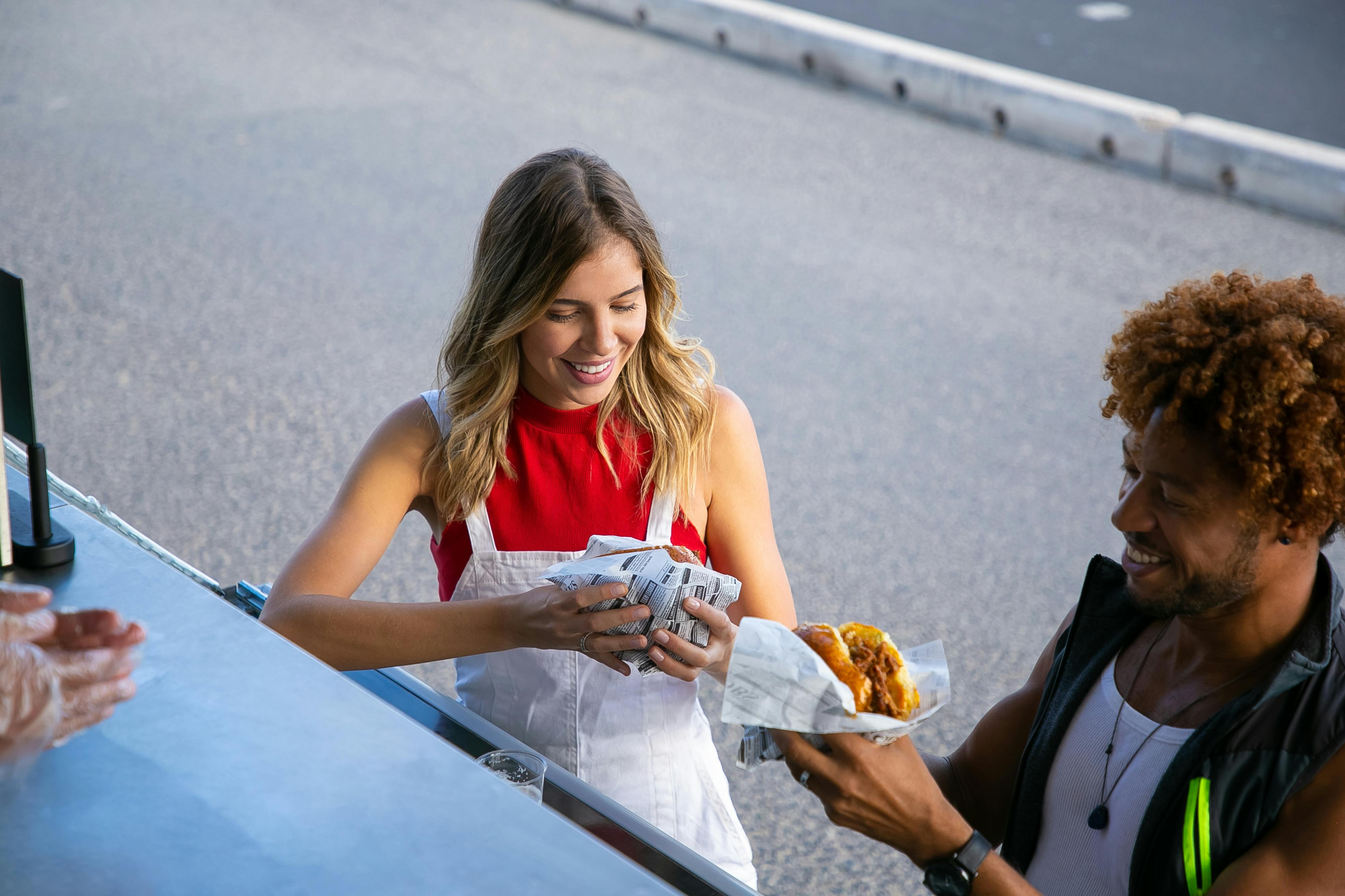 guy and girl eating burger at food truck