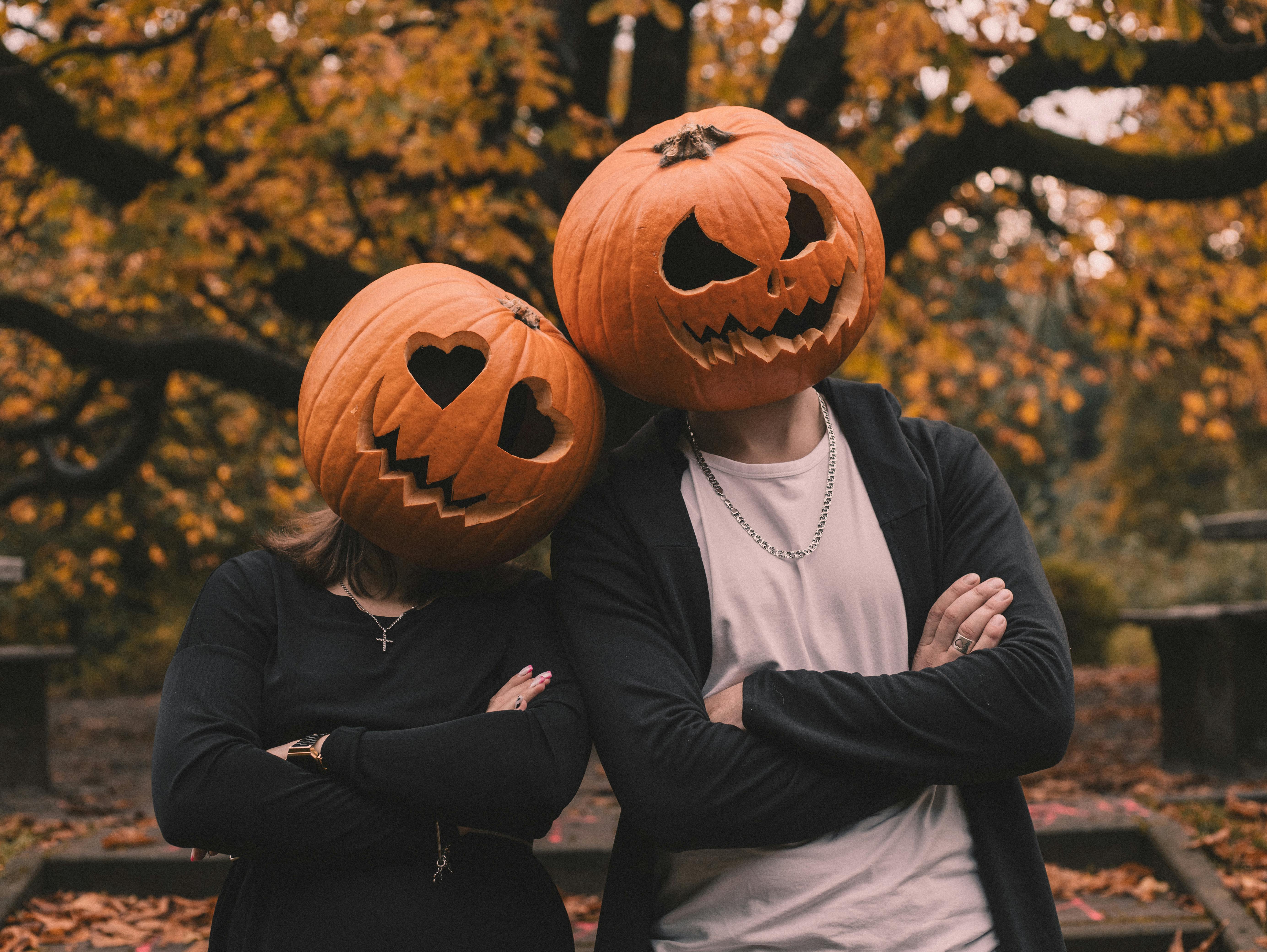 boy and girl with halloween pumpkin on their head
