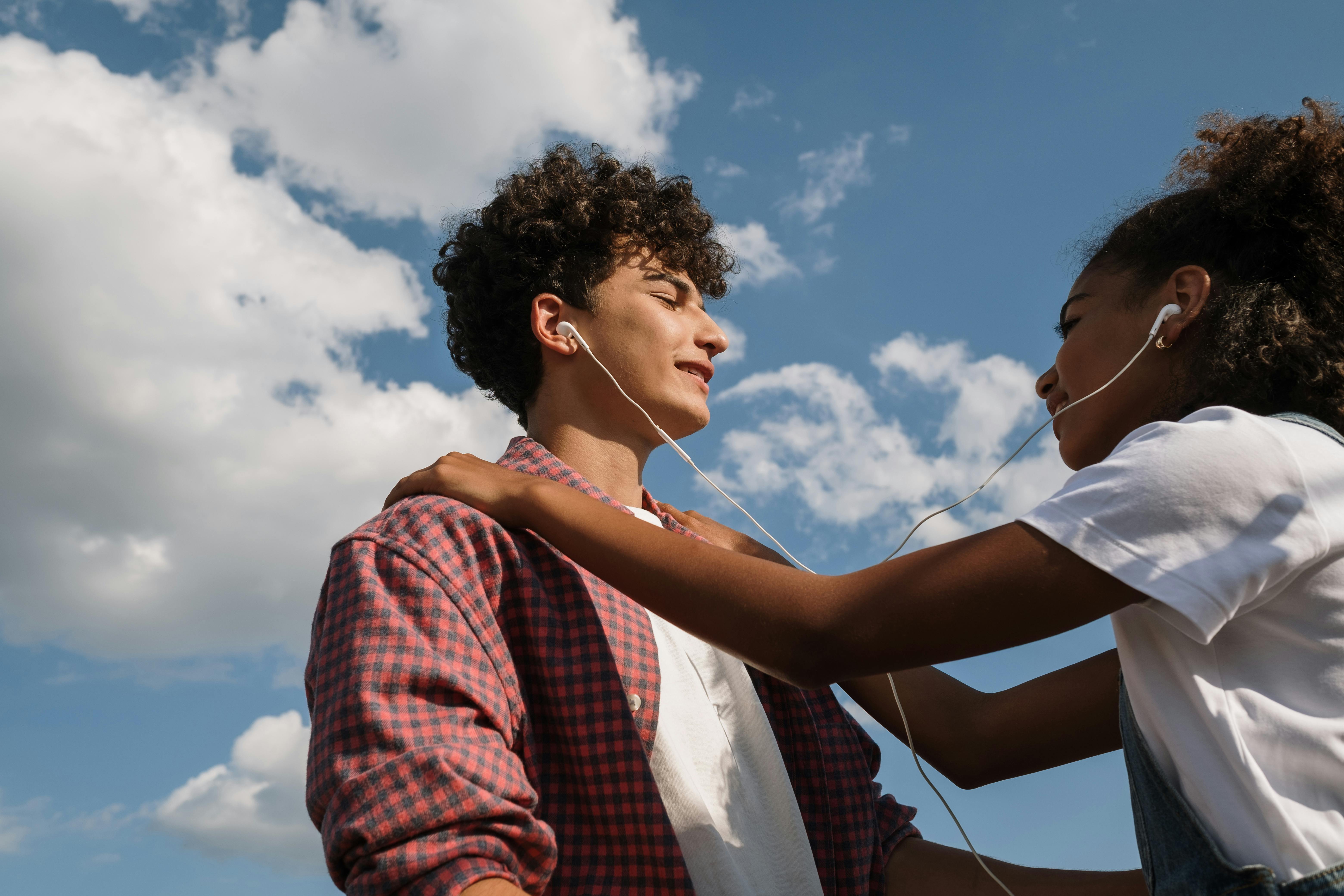 boy and girl listening to music in headphones