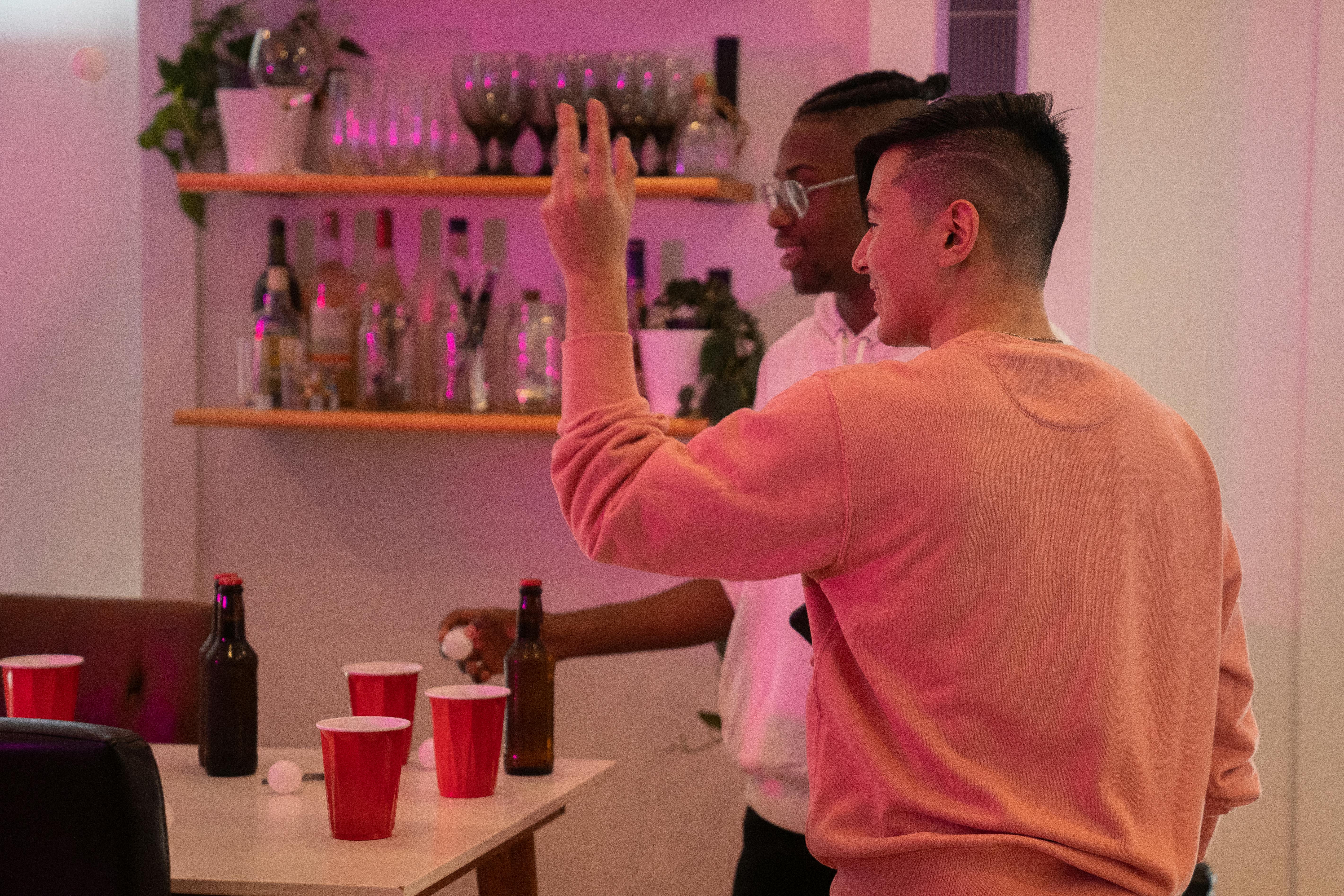 two guys playing beer pong 