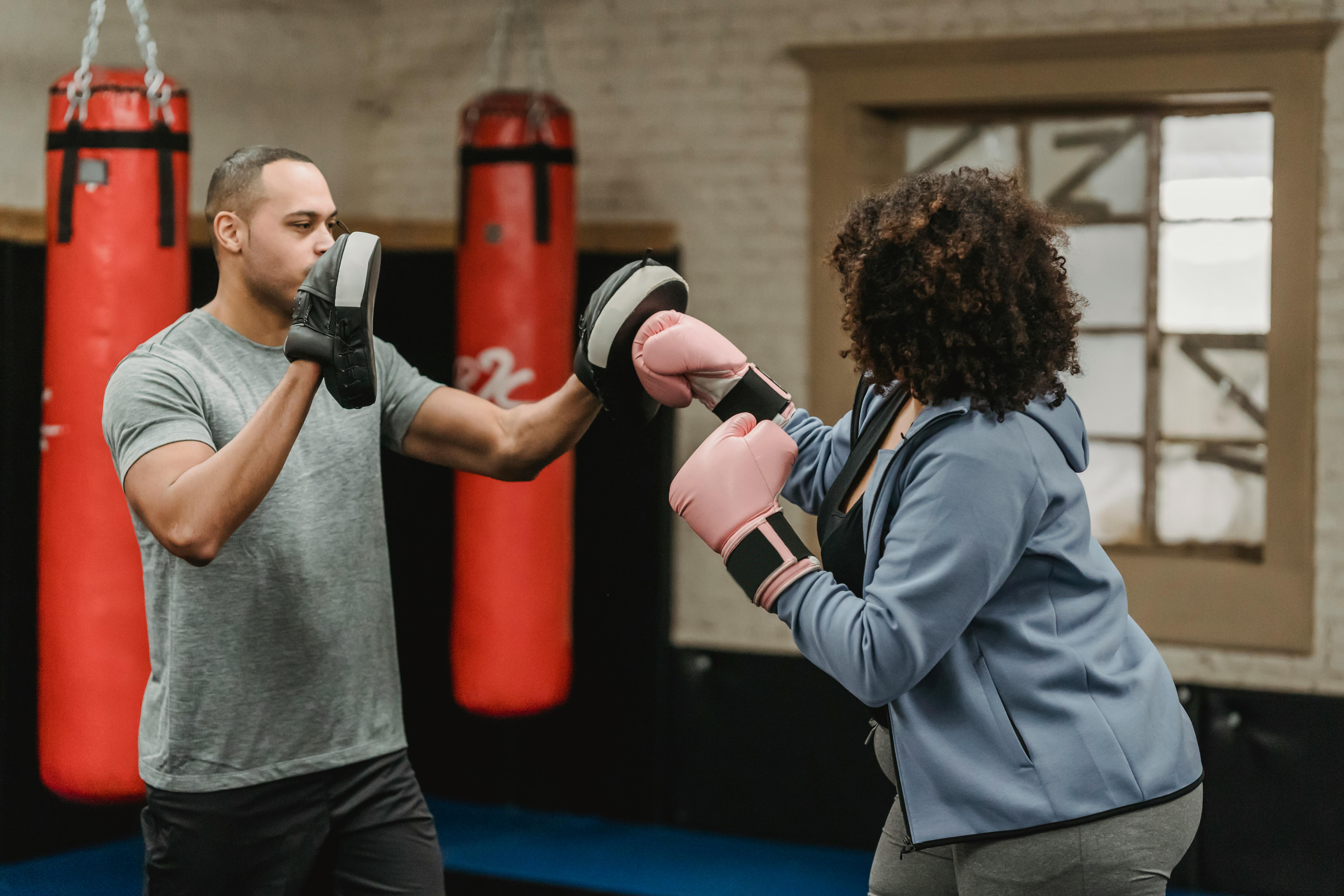 man and woman boxing in self defence class