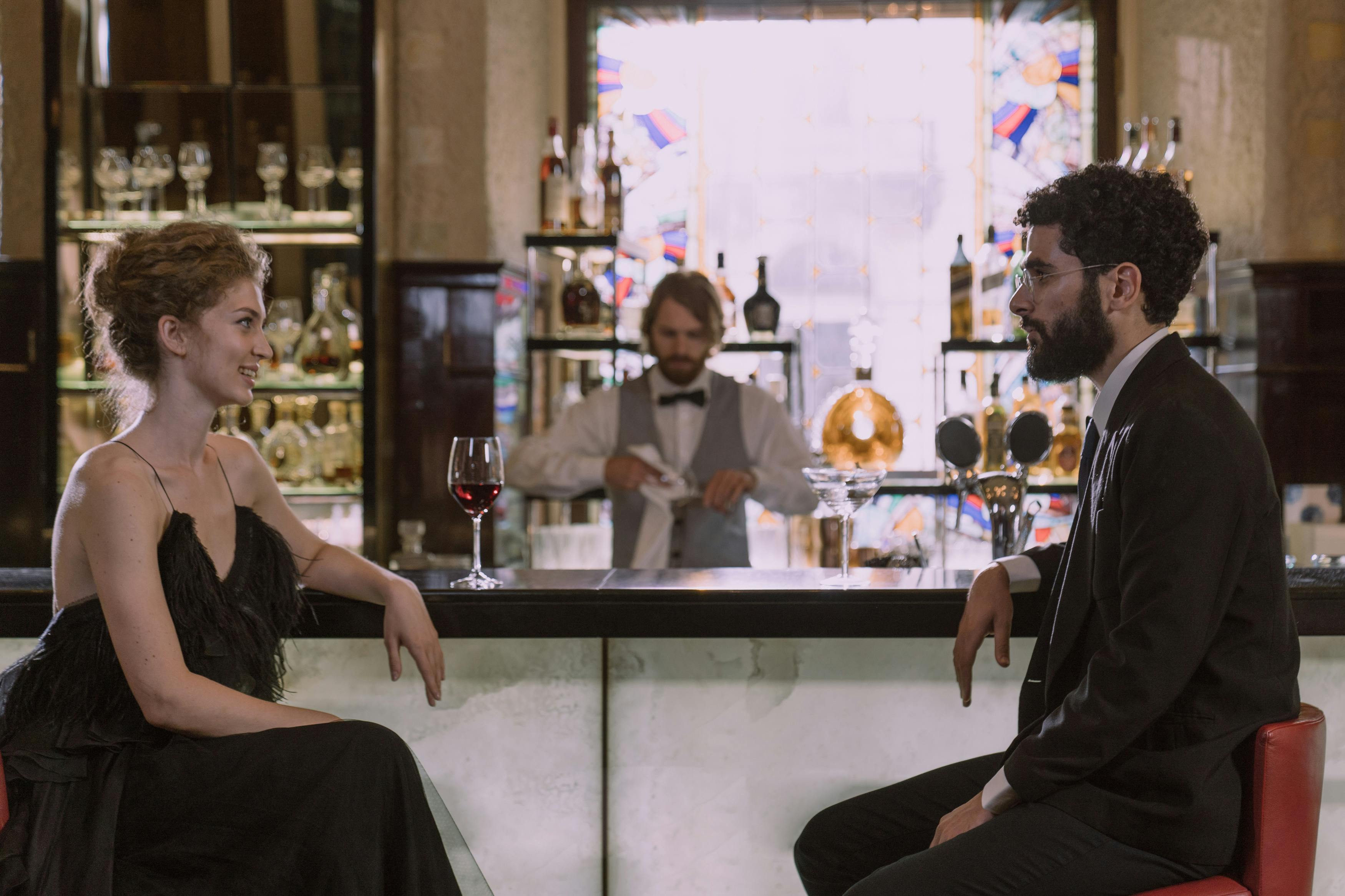 man and woma in bar drinking in a cocktail