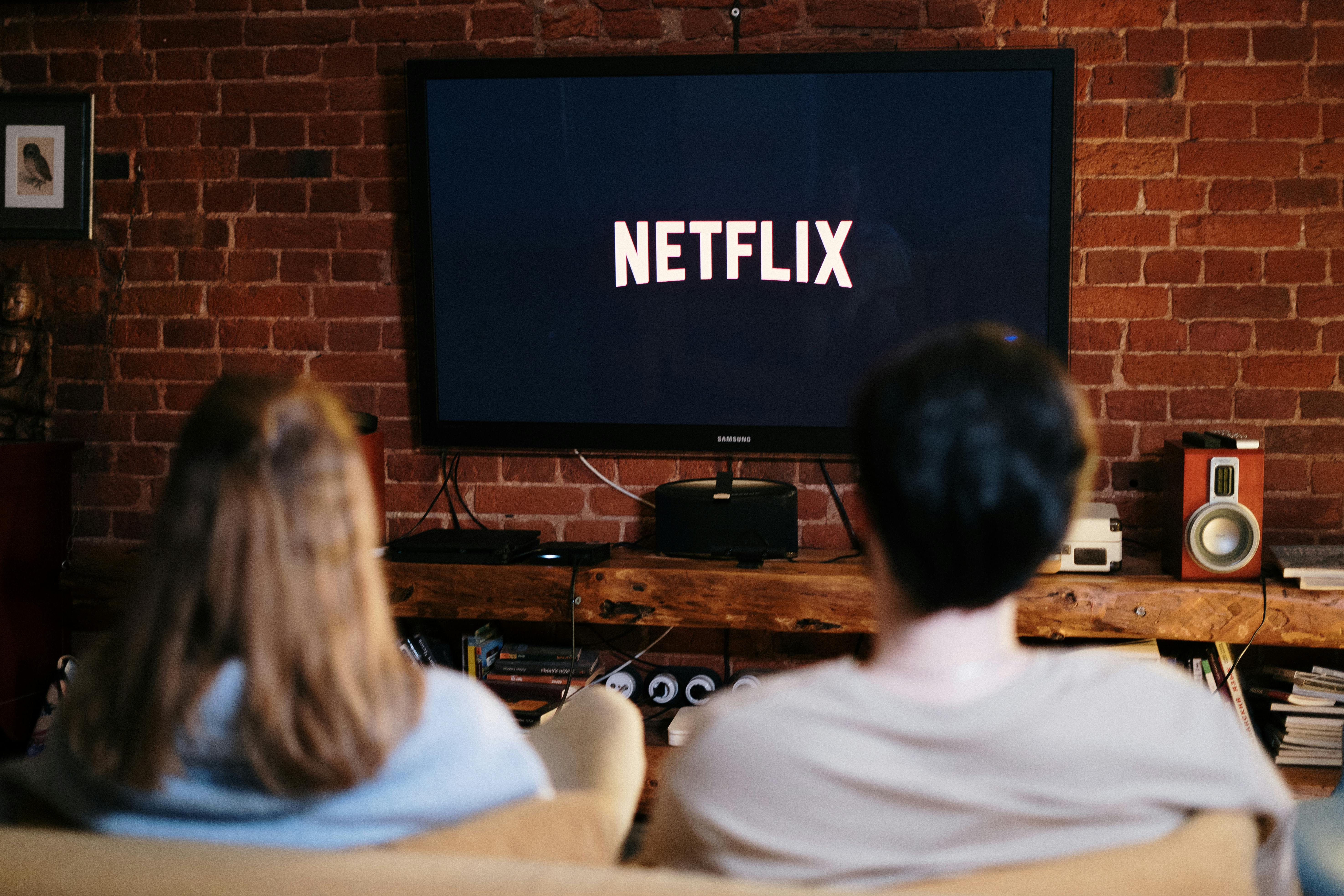 couple on couch watching netflix