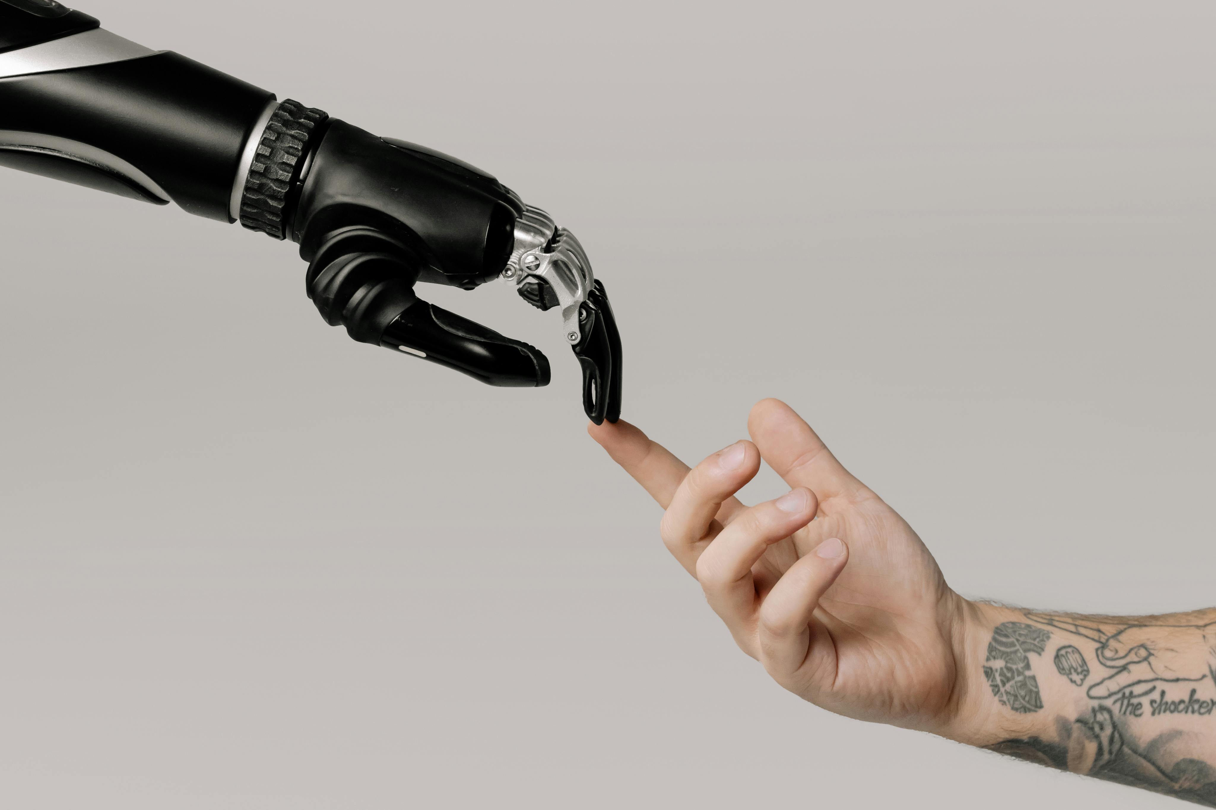 man's hand touching AI robot's hand